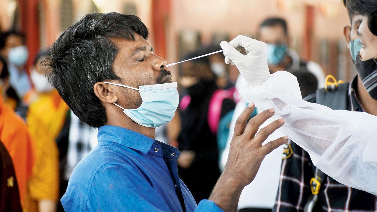 Swab sample of a passenger being taken at Dadar, on February 16. Pic/Ashish Raje