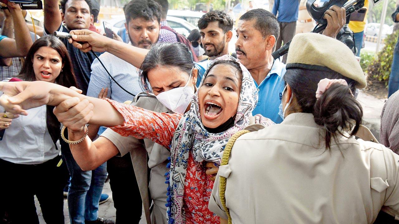 Cops detain a woman for protesting against the demolition of the illegally constructed houses in the wake of Nupur Sharma`s alleged remarks on Prophet Mohammad, in New Delhi on Monday. Pic/ANI