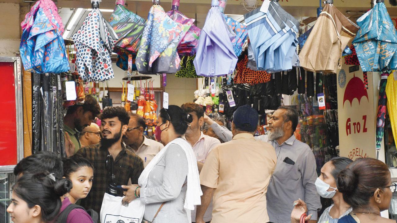 People shop for umbrellas and raincoats at Dadar market. File pic/Ashish Raje