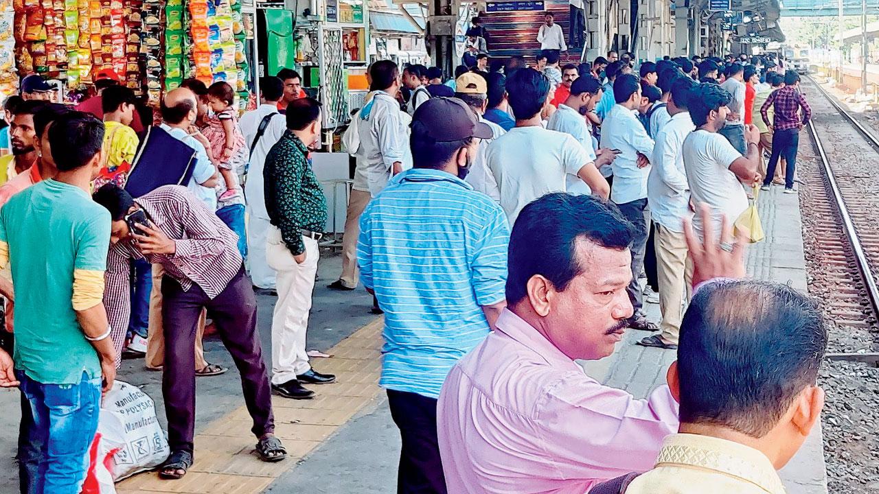 Commuters, most of them without a mask, wait for a train at Borivli on Sunday. Pic/Nimesh Dave