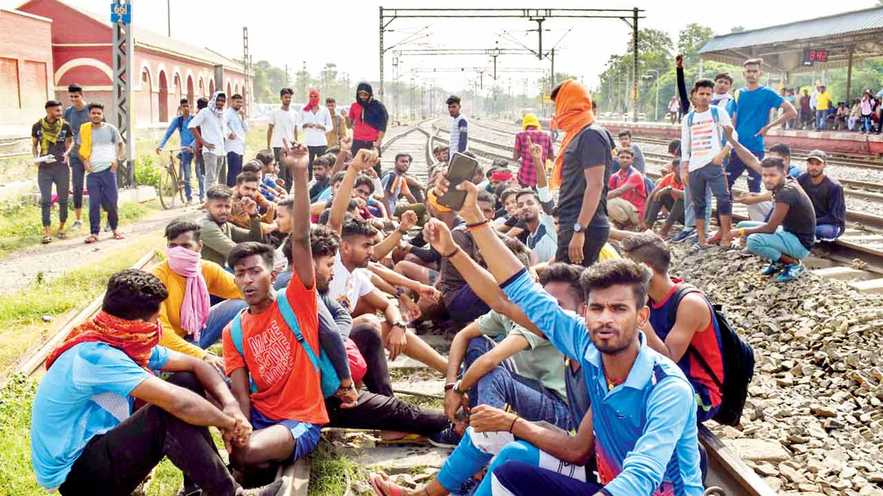Youngsters block tracks at Buxar station, in Bihar on Thursday. Pics/PTI