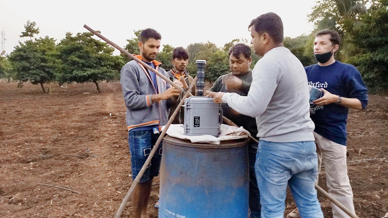 A team of Healthy Energy Initiative (India) seen setting up an air sampler device at a chikoo farm in Dahanu. The team conducted a 24-hour air sampling exercise at 12 locations in Dahanu in the last week of January