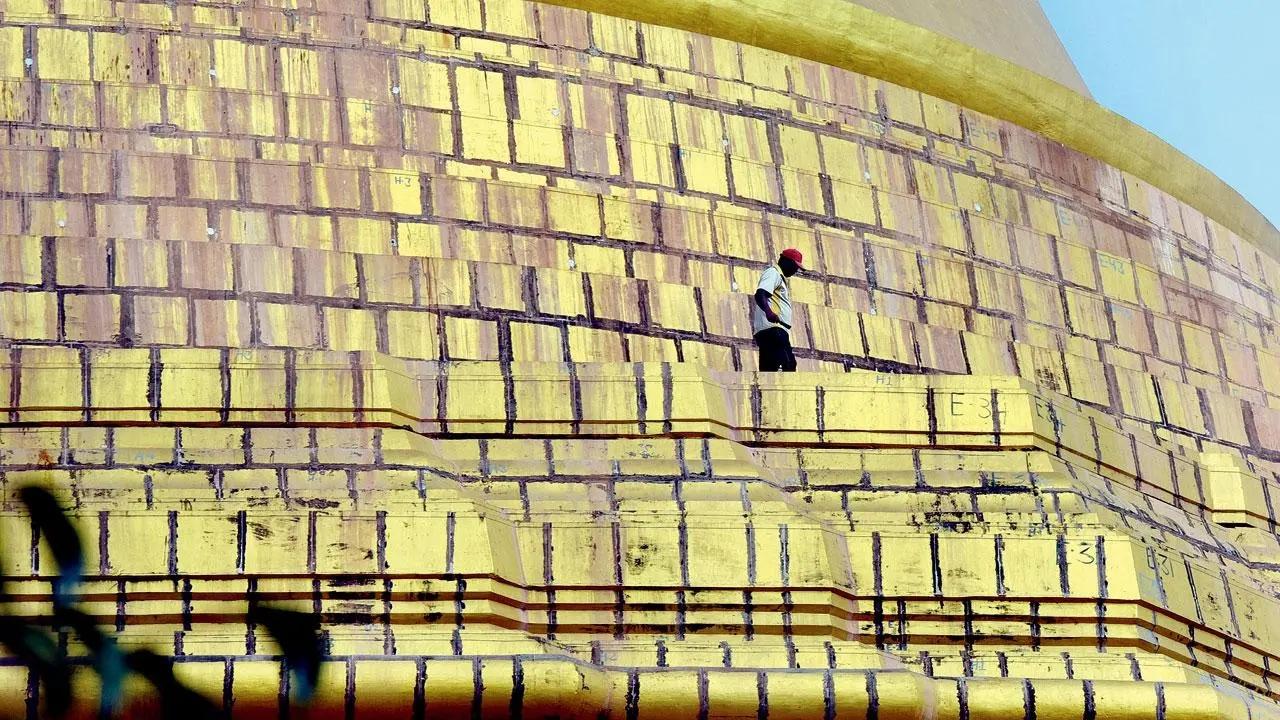 All that Glitters: A worker supervises the paint on the dome of Global Vipassana Pagoda at Gorai. Pic/Nimesh Dave