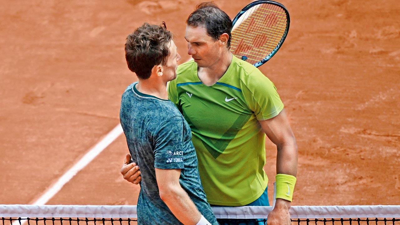 Rafael Nadal hugs Casper Ruud at the net after their French Open final