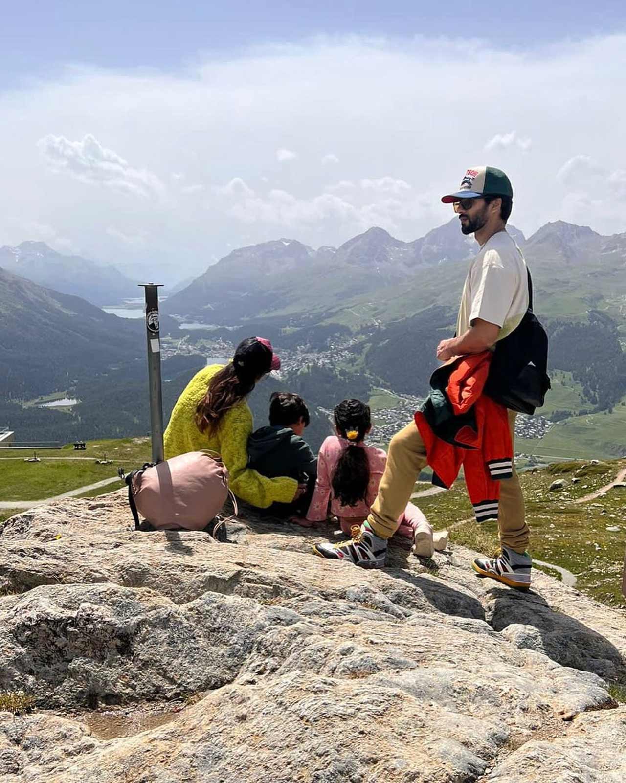 Shahid shared a serene picture of the beautiful destination of Switzerland. His two kids were seated on the lush green grass alongside their mother, while Shahid stood, facing his back to the camera