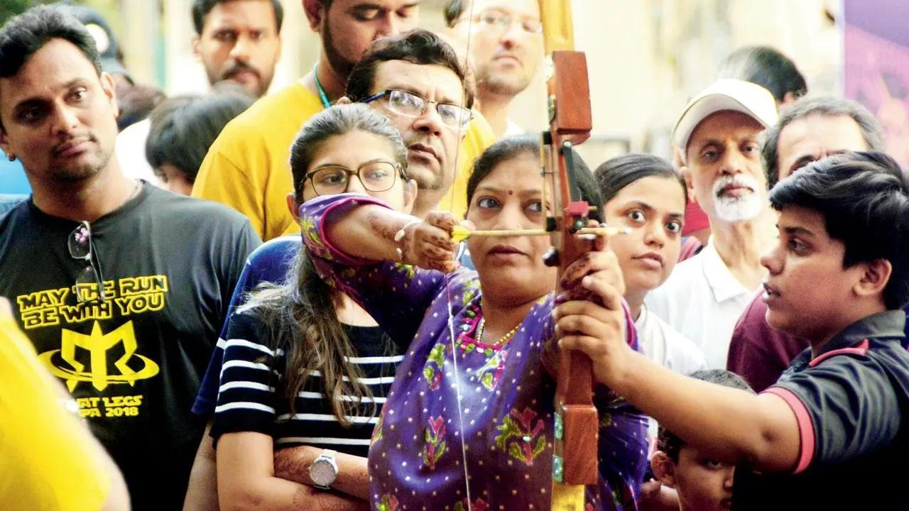 Aiming for bullseye: A woman tries her hand at archery during the Sunday Streets programme initiated by the Thane Police and KDMC at Phadke Road in Dombivli. Pic/Satej Shinde