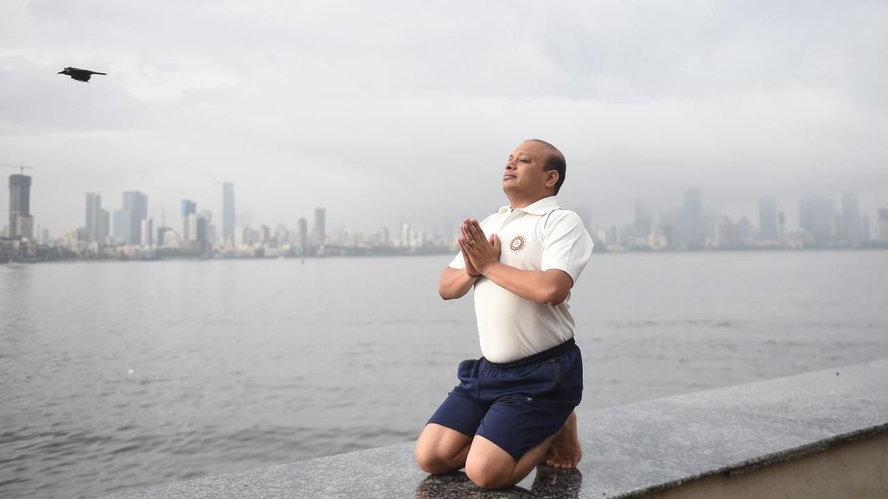 A man practices yoga at Bandra Reclamation on the 8th International Day of Yoga Day, in Mumbai. Pic/PTI