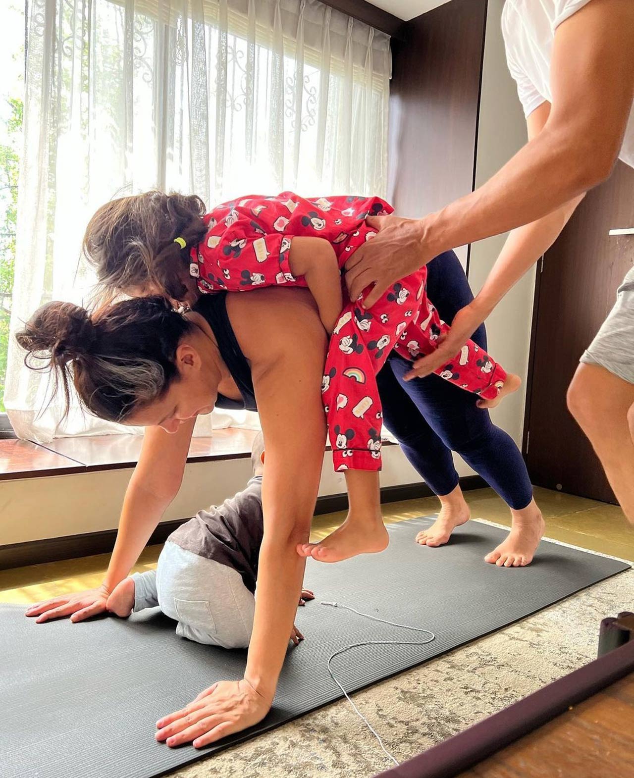 Bollywood actor Neha Dhupia took to social media to share a glimpse of a cute yoga session with her kids, Mehr and Guriq and talked about how embracing motherhood was a 'fine balance'.
