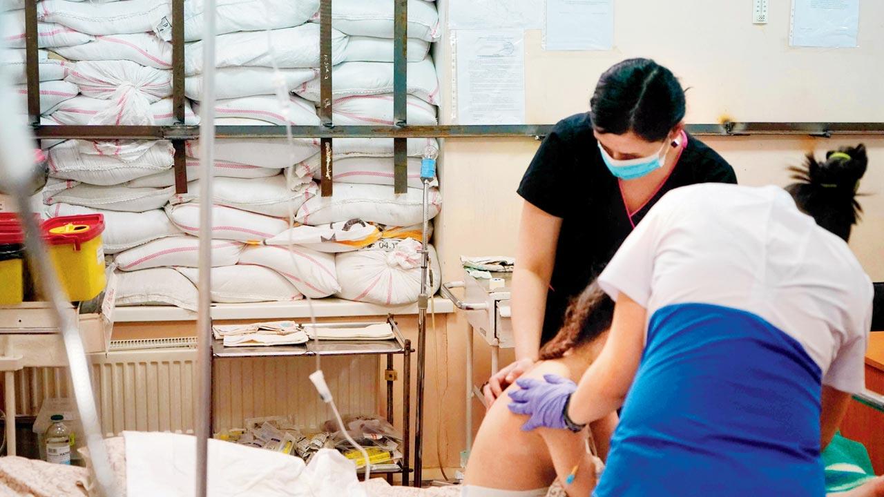 Nurses tend to a child in a room protected by sandbags at Zaporizhzhia Regional Clinical Children’s Hospital on Tuesday.