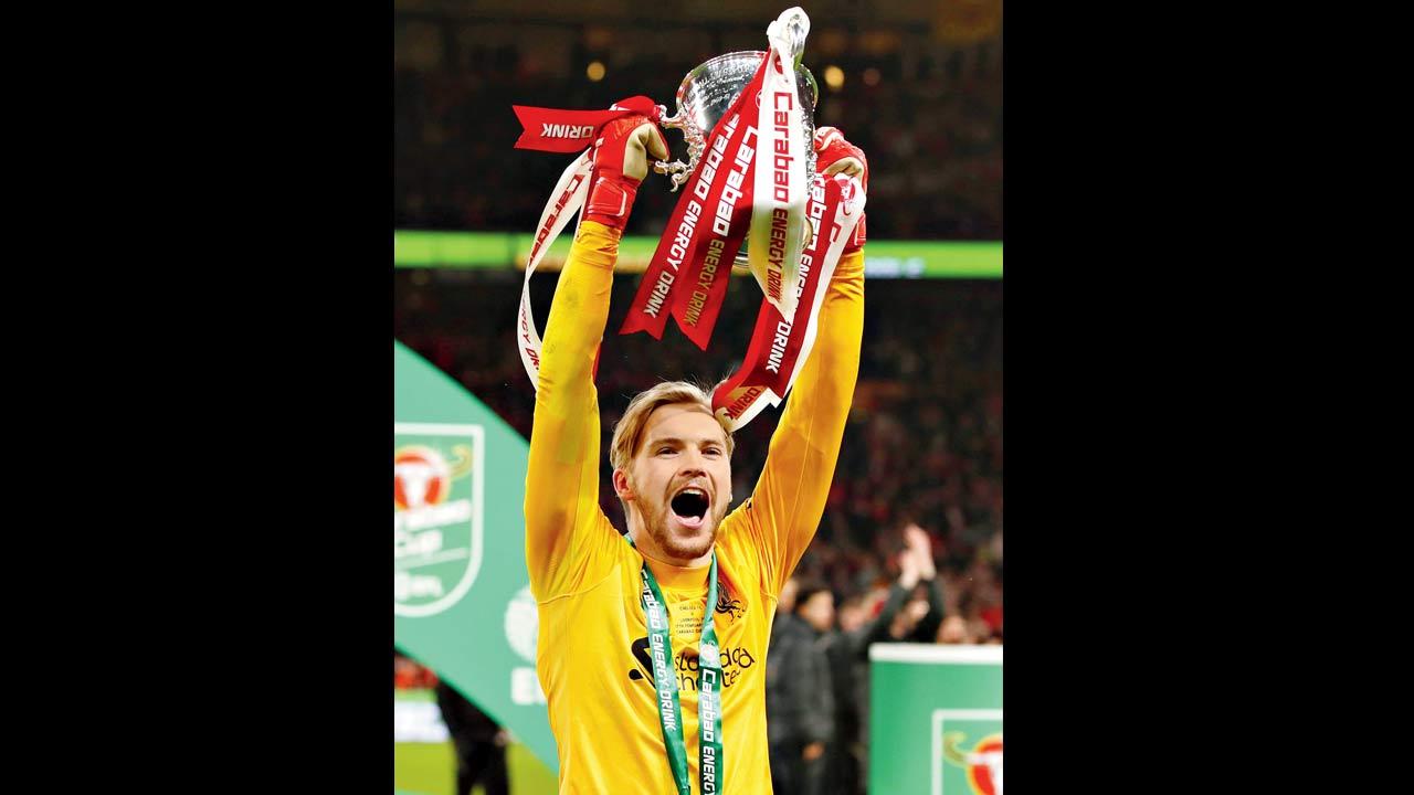 Liverpool goalkeeper Caoimhin Kelleher lifts the English League Cup after helping his side win the final against Chelsea on Sunday. Pic//AFP