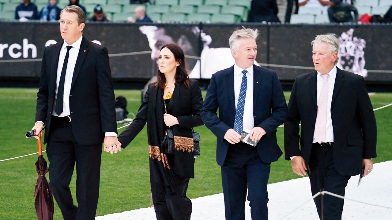 Former Australian cricketers Glenn McGrath (extreme left) and Steve Waugh (2nd from right) arrive to attend the state memorial service at the Melbourne Cricket Ground yesterday