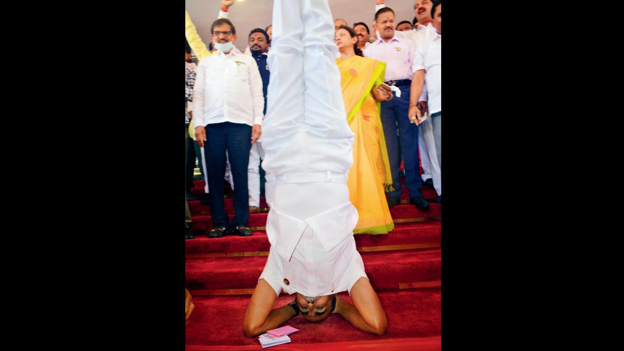 Shiv Sena legislator Sanjay Daund protests by doing shirshasana on the steps of the Vidhan Bhavan