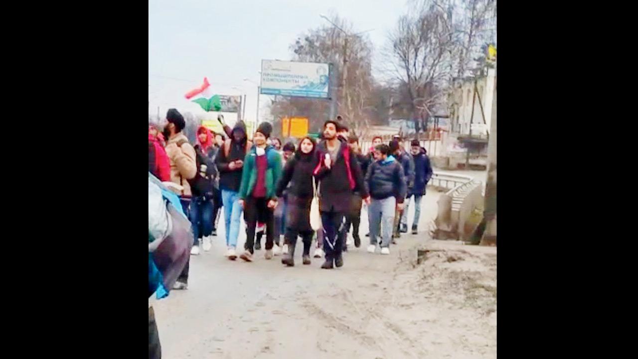 Students walk from Kharkiv to Pesochin on Wednesday