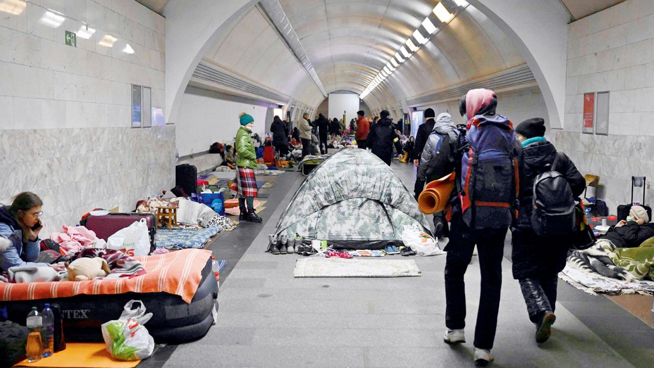 Civilians take shelter in an underground metro station in Kyiv. Pic/AFP