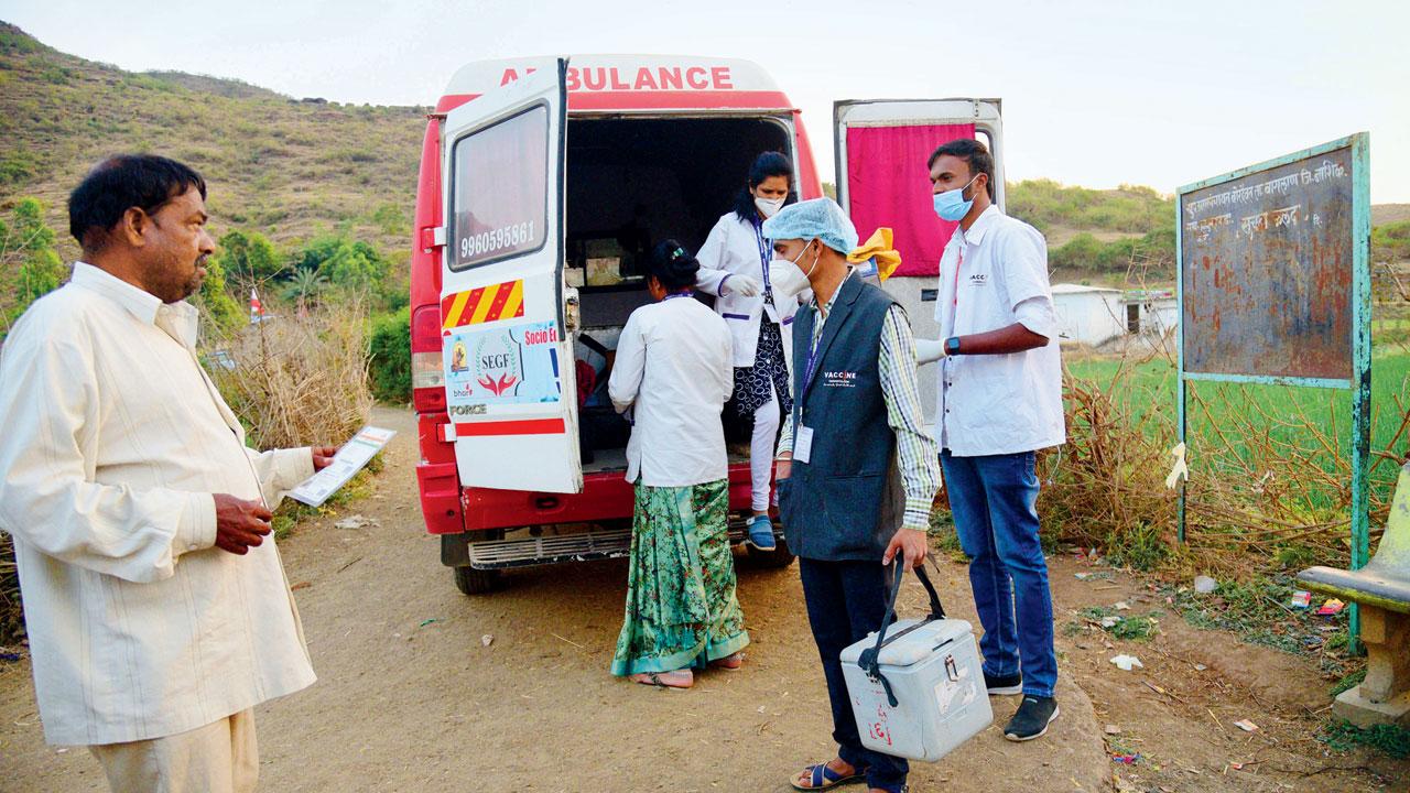 Health staff from Satana city, 40 km away, arrive in a COVID ambulance to vaccinate tribal residents of Aliyabad