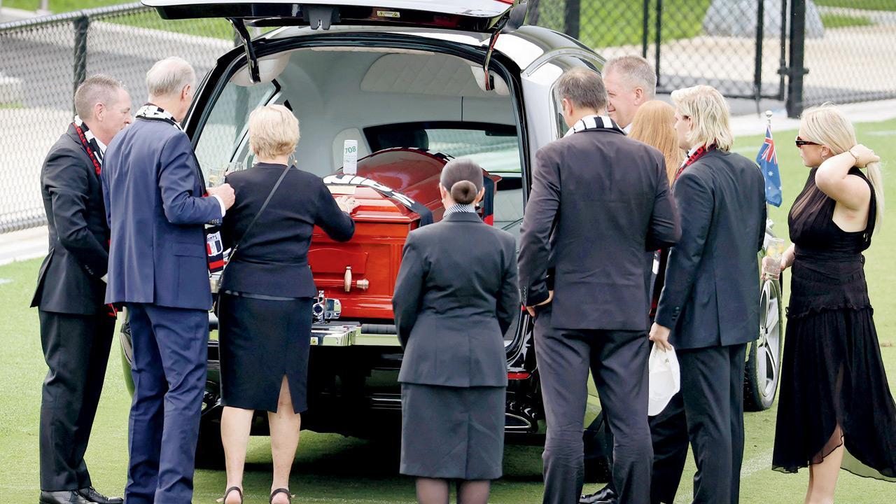 Warne’s family and friends say goodbye at private funeral