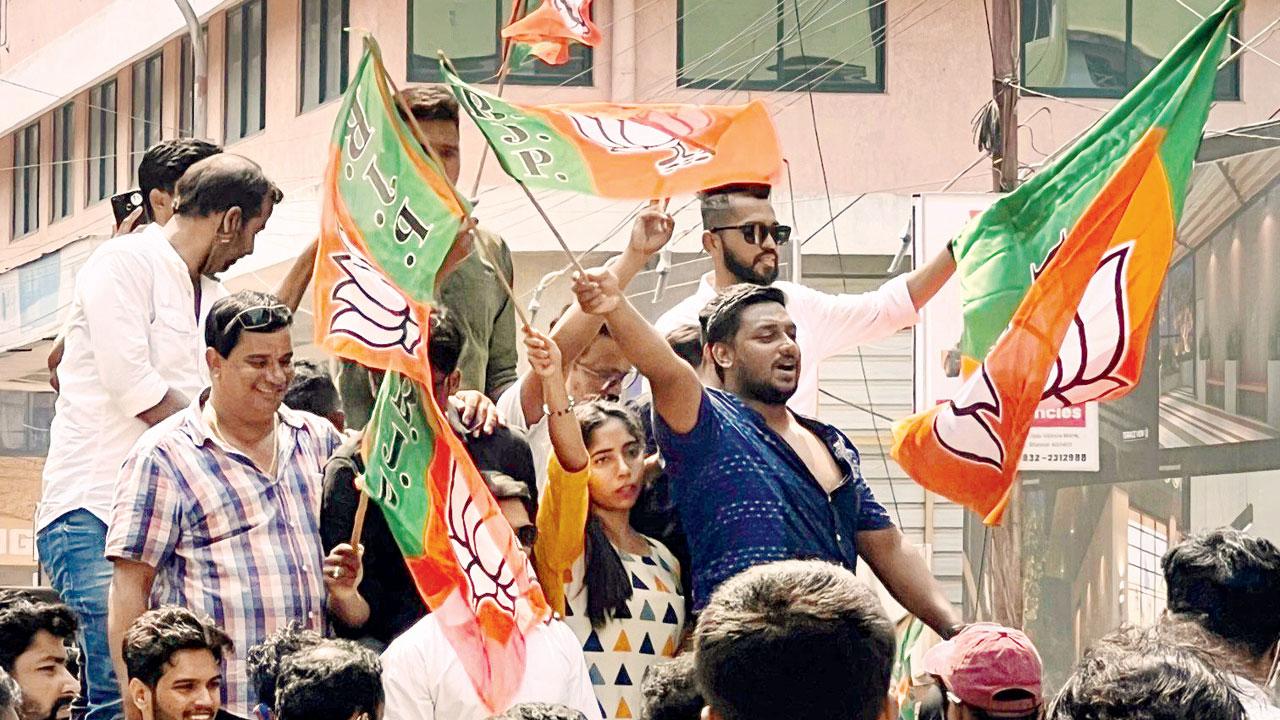  BJP workers celebrate outside the party office in Panaji