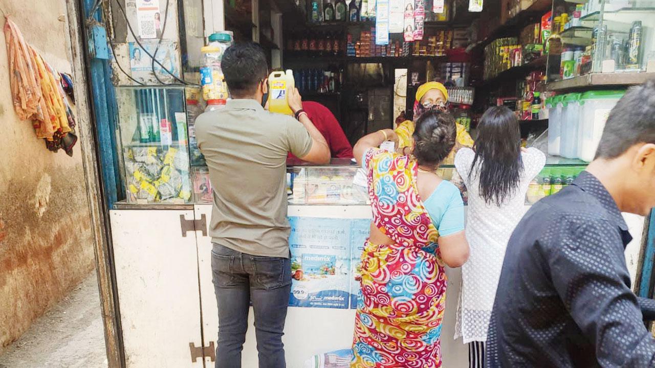 mid-day correspondent (in olive t-shirt) buys acid from a Dahisar shop