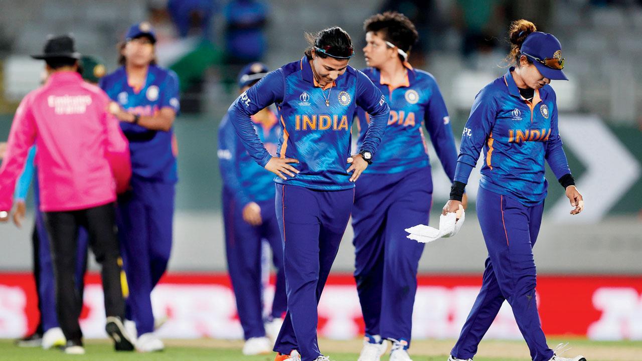 India skipper Mithali Raj (right) leads her team off the field after losing to Australia at Eden Park, Auckland, on Saturday. Pics/Getty Images, AFP