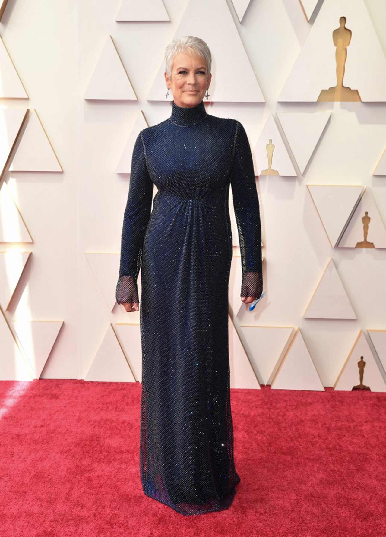 Jamie Lee Curtis appeared in a shimmery midnight blue Stella McCartney dress, showing off a ribbon honouring refugees.