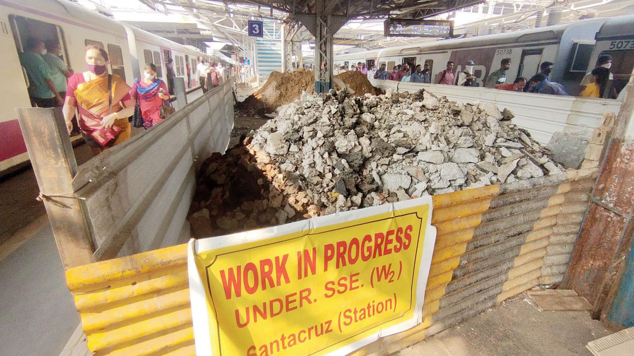 Commuters walk next to the dug up portion of platforms 3, 4. Pic/Rajendra B. Aklekar