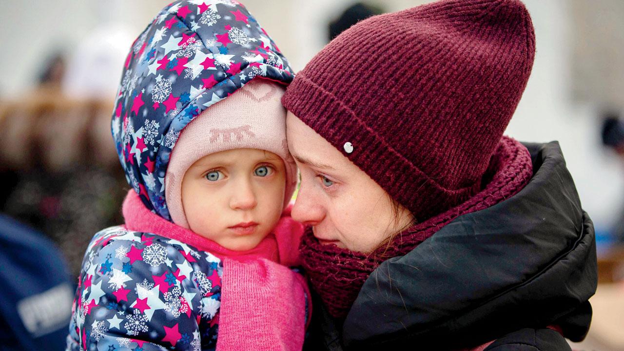 Medyka, Poland: A mother and child, fleeing Ukraine, wait at the border crossing in Medyka, Poland