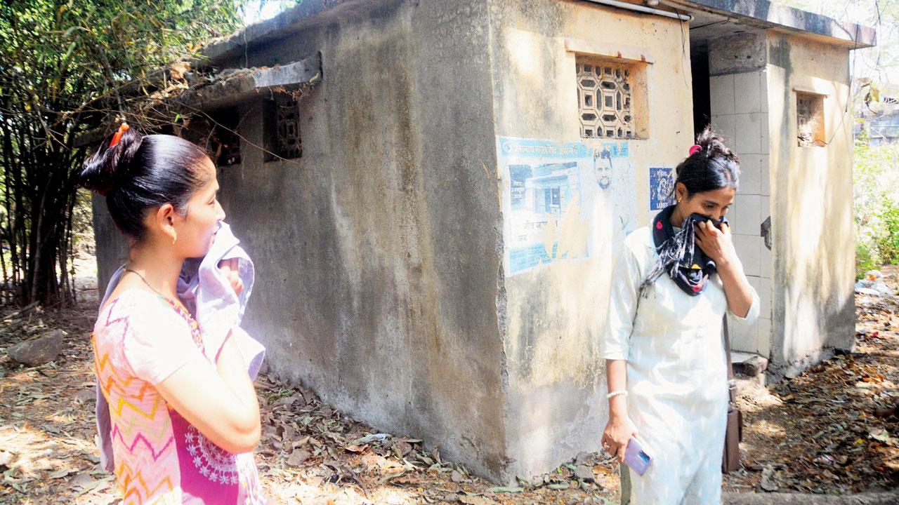 Reshma Babita Bhaskar Ahire, a member of the social organisation Anubhuti, seen outside a poorly-maintained toilet in Forest Naka, Ambernath, which is now infested with flies. Kiran Mohan Singh, a resident, says they send their children to defecate in the open. “We can’t send them to take a dump in such a filthy toilet. They will catch diseases”