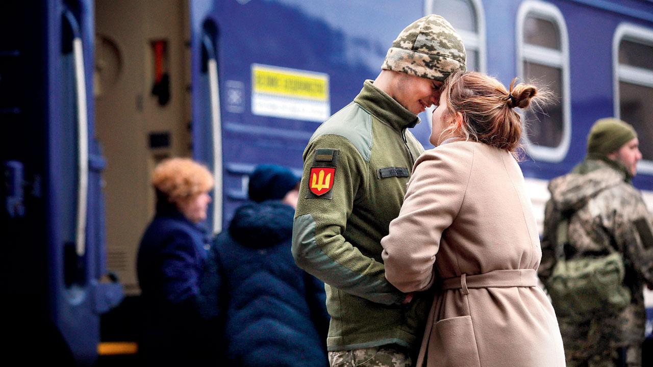A Ukrainian serviceman with his girlfriend before leaving. Pic/AFP