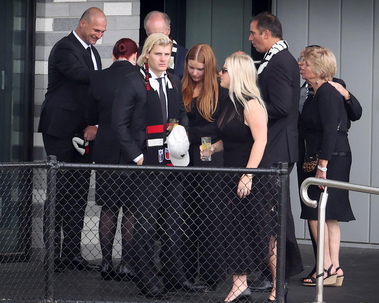 The family watches the hearse carrying Australian cricket superstar Shane Warne depart after a lap of the ground during a private memorial service at the St Kilda Football Club in Melbourne on March 20, 2022