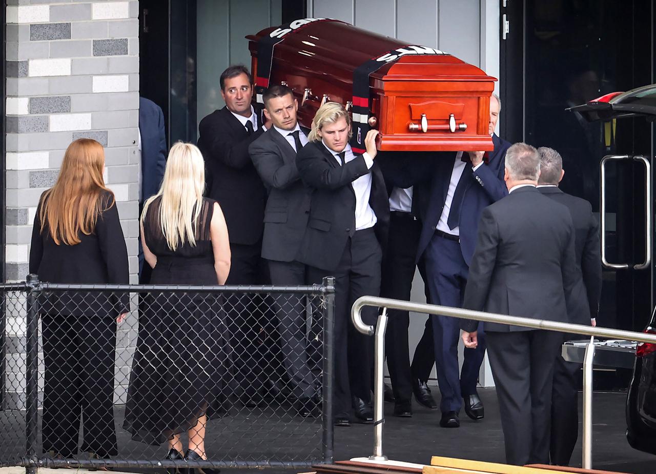 The coffin of Shane Warne is carried out by his son Jackson following a funeral service in Melbourne, Australia, Sunday, March 20, 2022. Warne‚Äôs family and friends have attended a private funeral in his hometown of Melbourne to pay their final respects to the cricketing legend.