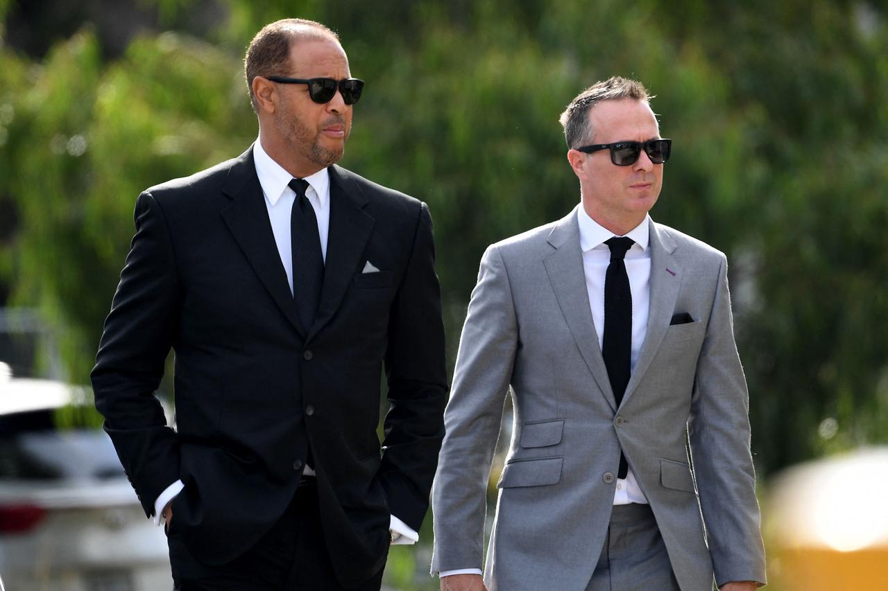 Former Australian cricketer Andrew Symonds (L) and former England cricketer Michael Vaughan (R) arrive for a private memorial service for Australian cricket superstar Shane Warne in Melbourne