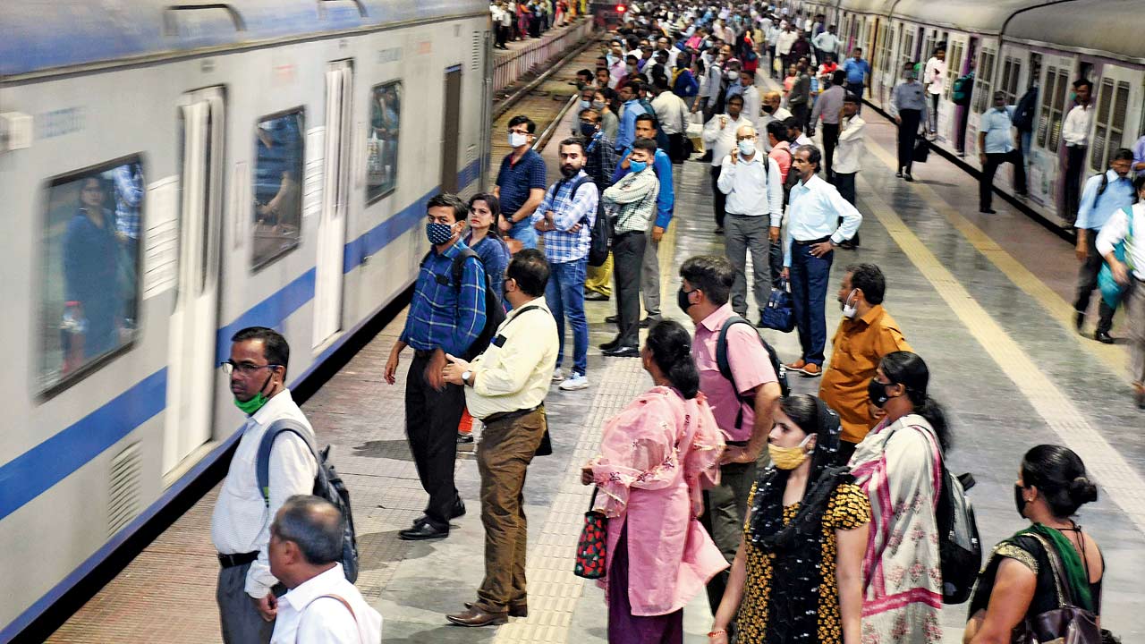 Commuters wait to board the AC local train as it arrives at CSMT. File pic/Ashish Raje