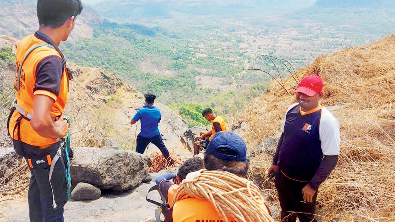 Shivdurga Mitra volunteers prepare to rappel down a mountain during the search