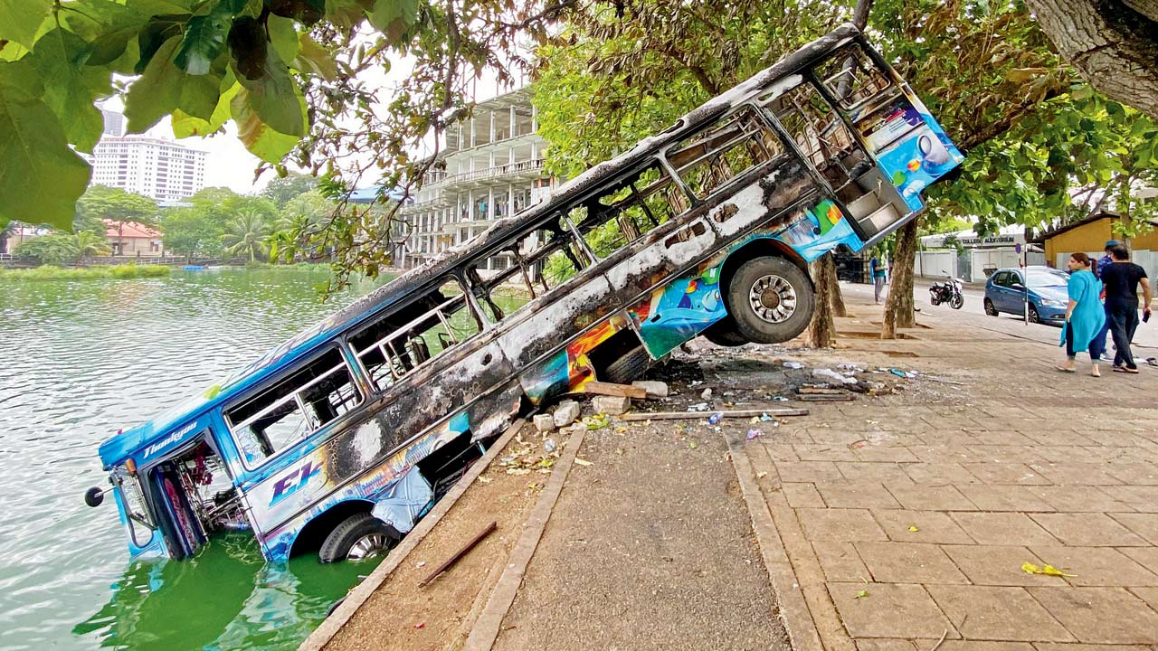 Burnt buses near Mahinda Rajapaksa’s official residence in Colombo on Tuesday