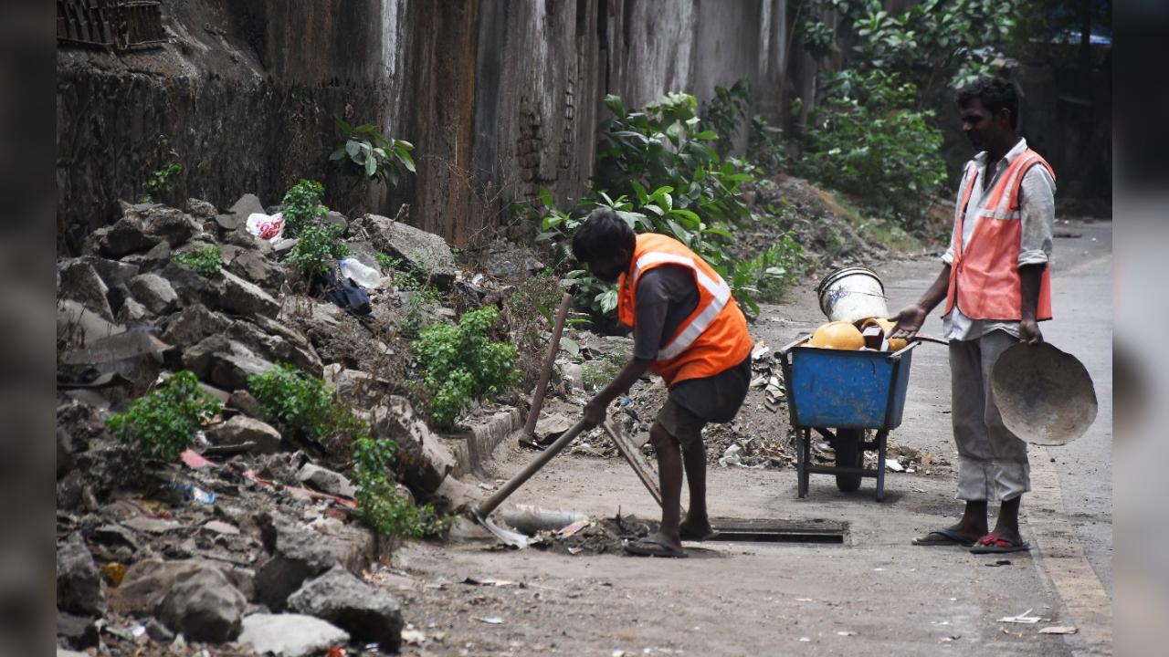 BMC contract workers cleaning gutter before monsoon at P D'Mello road at Mazgaon on  20/05/22. PHOTO BY--ASHISH RAJE