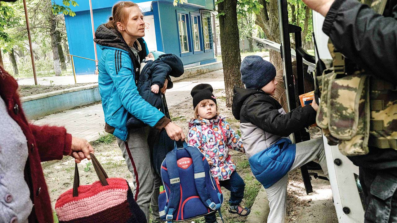 Nazar (right) boards a bulletproof bus to evacuate with his family from the eastern Ukraine city of Lyman, which has received heavy shelling, on Monday. Pic/AFP