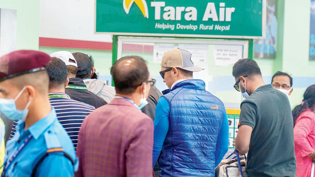 A signage of Tara Airlines is seen behind as a team of climbers prepare to leave for rescue operations, in Kathmandu, Nepal, on Sunday. Pic/PTI