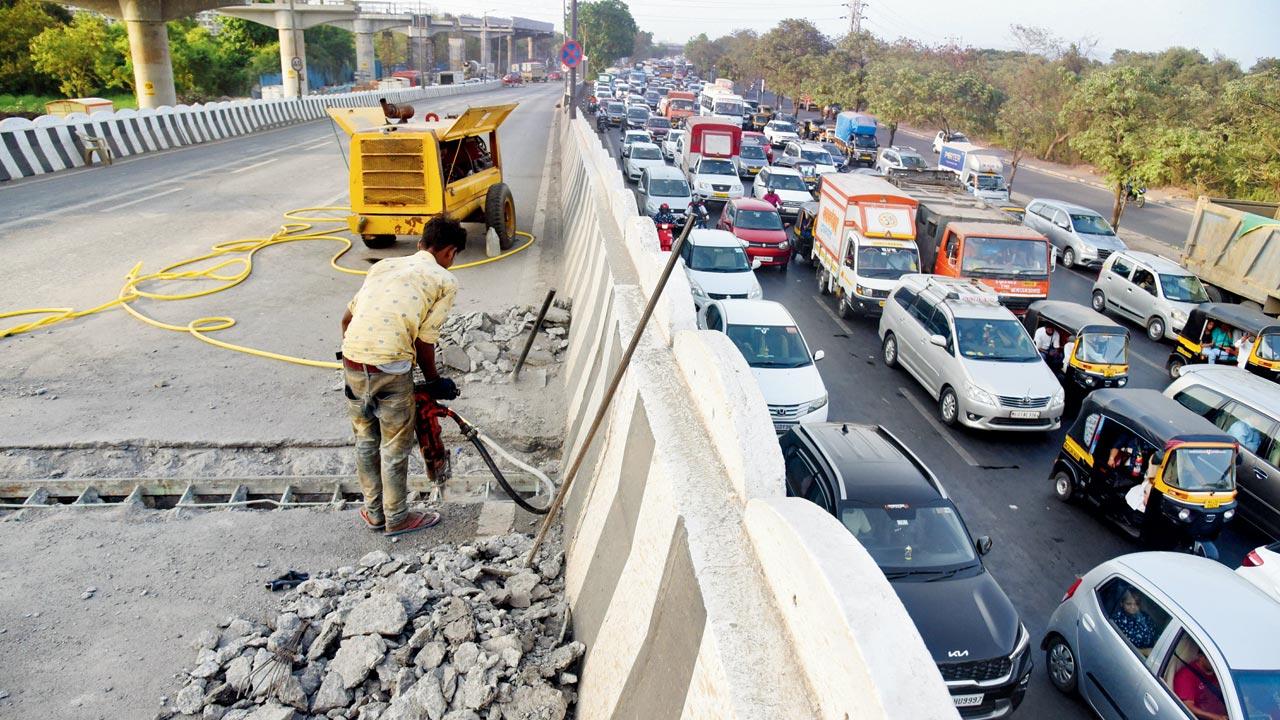 Maintenance of the flyover underway, on Monday. Pic/Sameer Markande