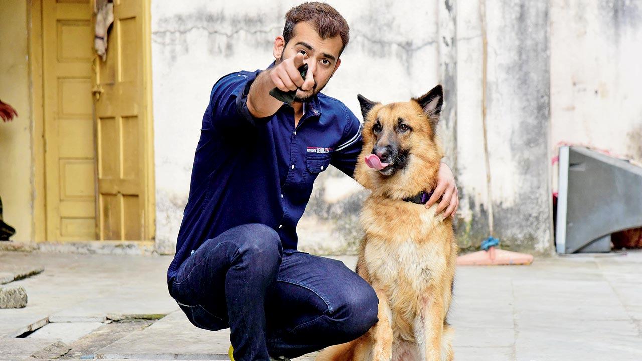German Shepherd Whiskey, who is a member of the Mumbai Police Dog Squad, with her handler. Pic/Suresh Karkera