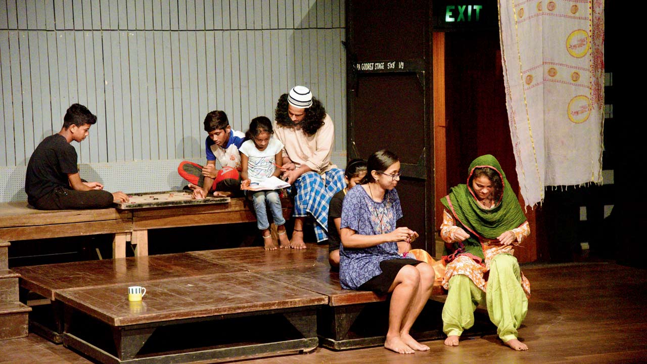 Trained actors and underprivileged children share a moment on the stage