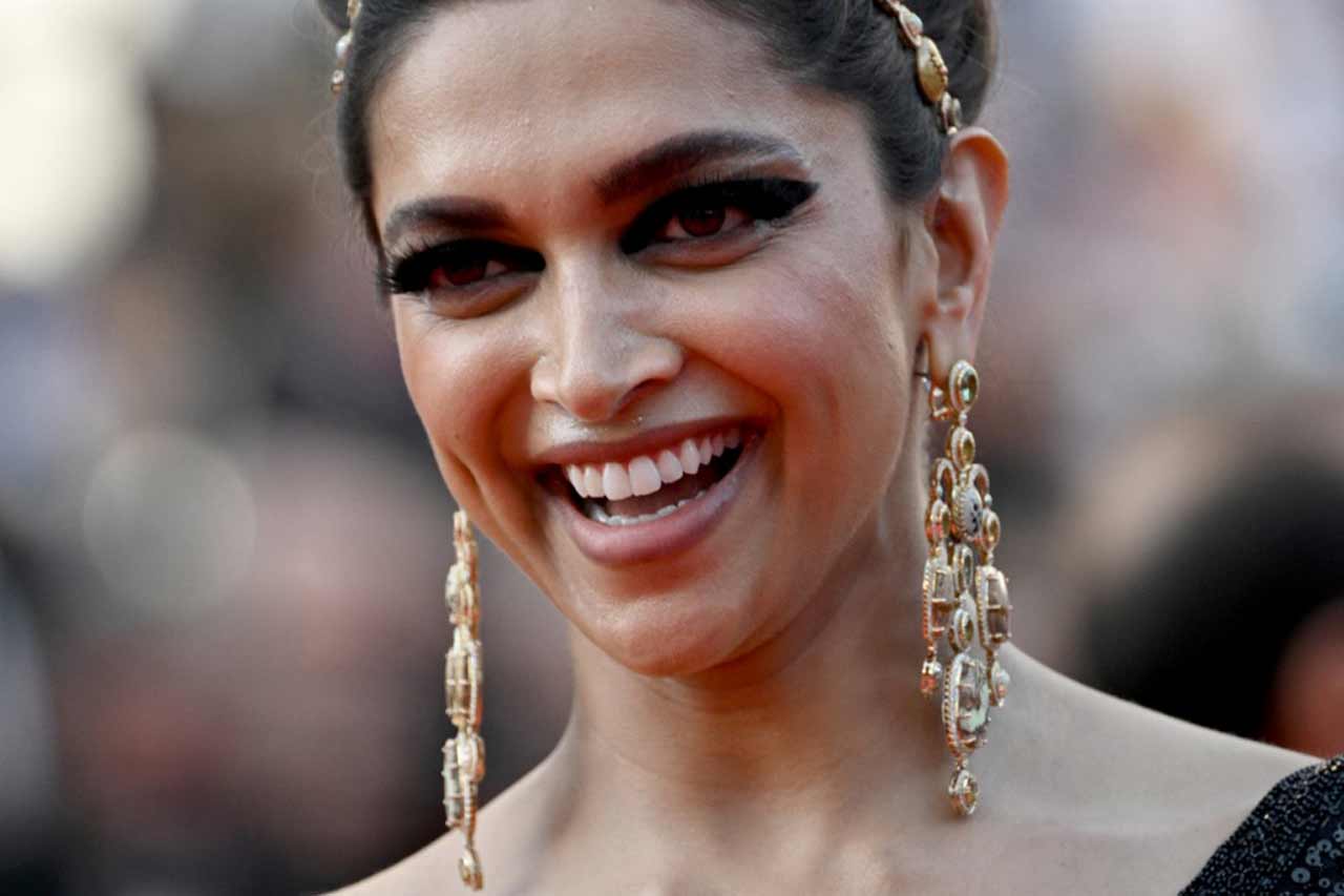 Speaking of her hair, she chose to tie them in a bun immaculately and accessorised it with a golden hairband. Sabyasachi, too, shared the pictures of Deepika's retro look on social media.