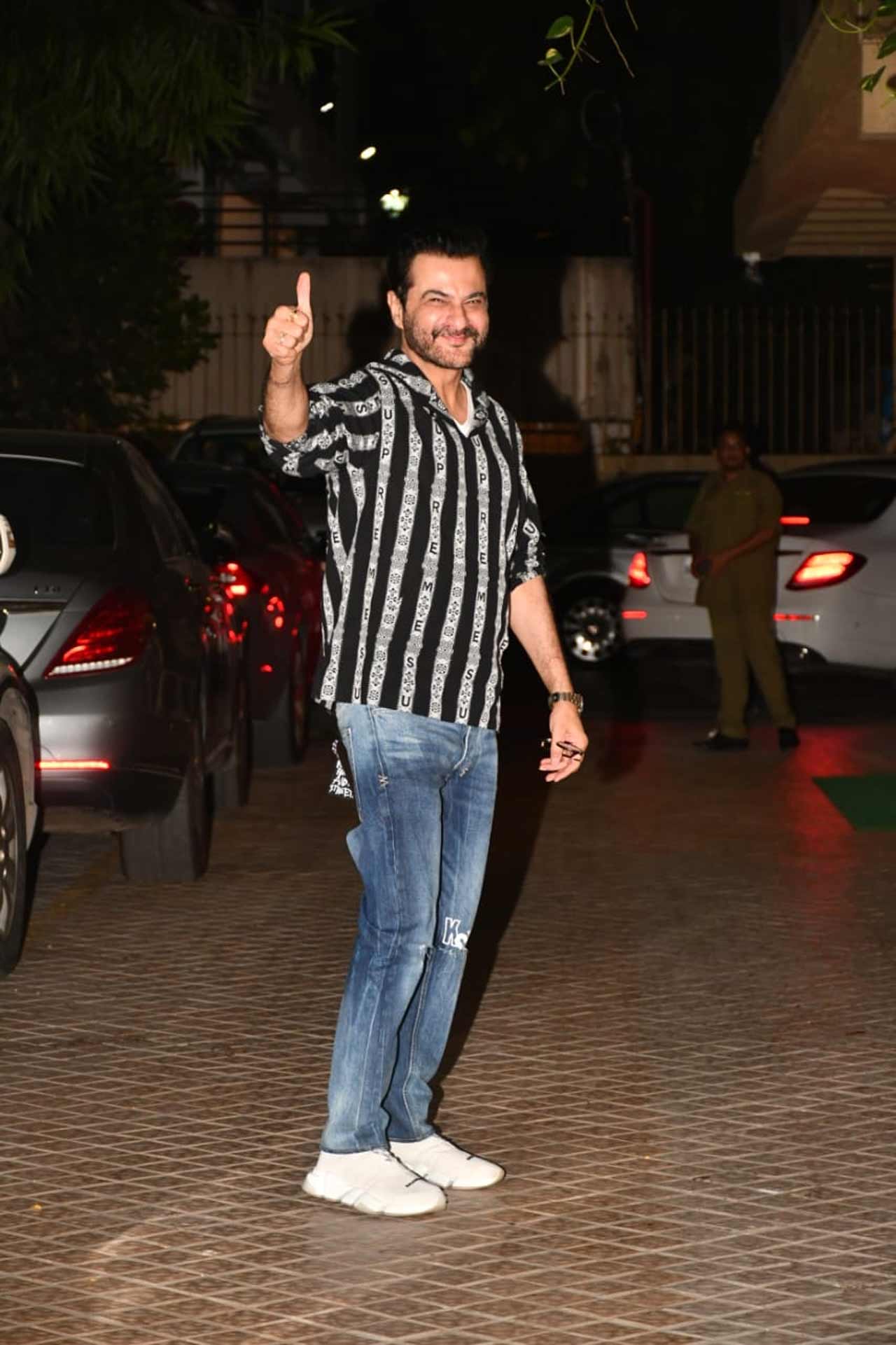 Sanjay Kapoor was seen wearing a striped shirt paired with a basic pair of denim during the outing.