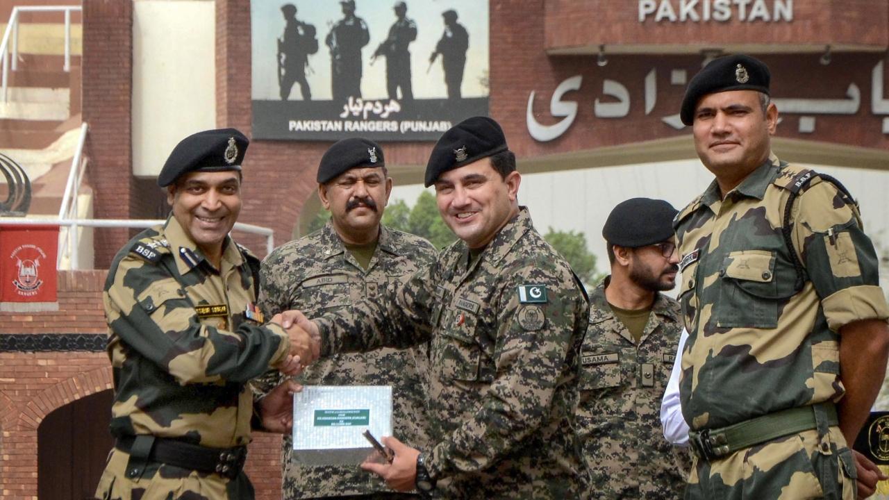 Border Security Force (BSF) Commandant Jasbir Singh greeets Pakistani Rangers Wing Commander Aamir on the occasion of the Eid al-Fitr festival, at the India-Pakistan Attari-Wagah border. Pic/PTI