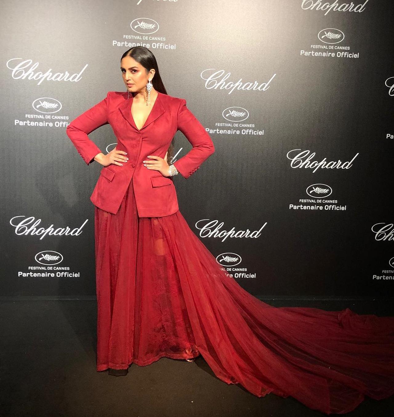 A red gown accompanied by a red coat, Huma captioned this picture as- 