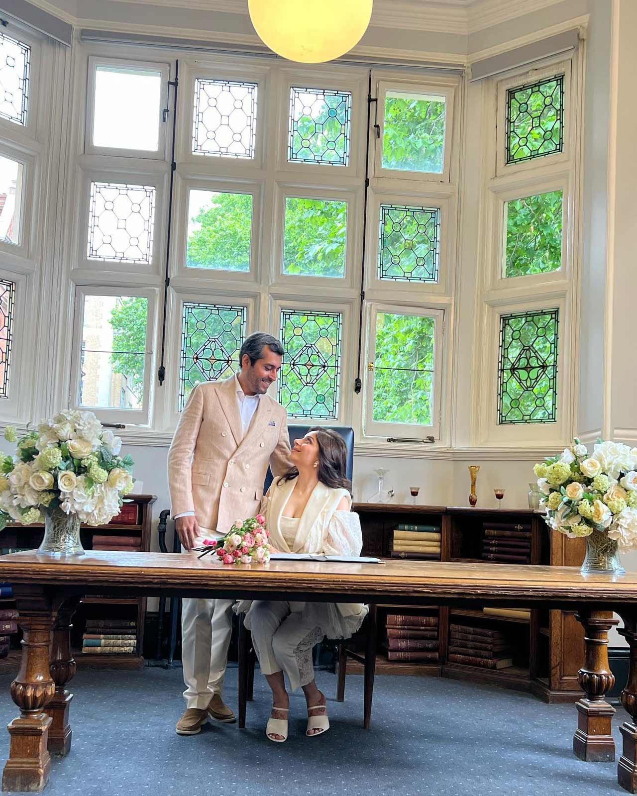 Kanika Kapoor could be seen wearing a lacey white pantsuit to her church wedding, while her husband Gautam chose to wear a beige coloured coat and white coloured shirt and pants.