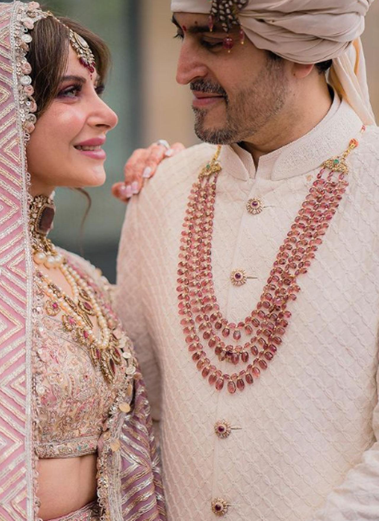 In the pictures, Kanika is seen wearing a pastel colour lehenga while Gautam complemented the bride with the pastel colour sherwani with a turban. For her special day, the 'Baby Doll' fame looked stunning in pastel pink heavy embroidered lehenga paired with choker necklace, mangtika and bangles.