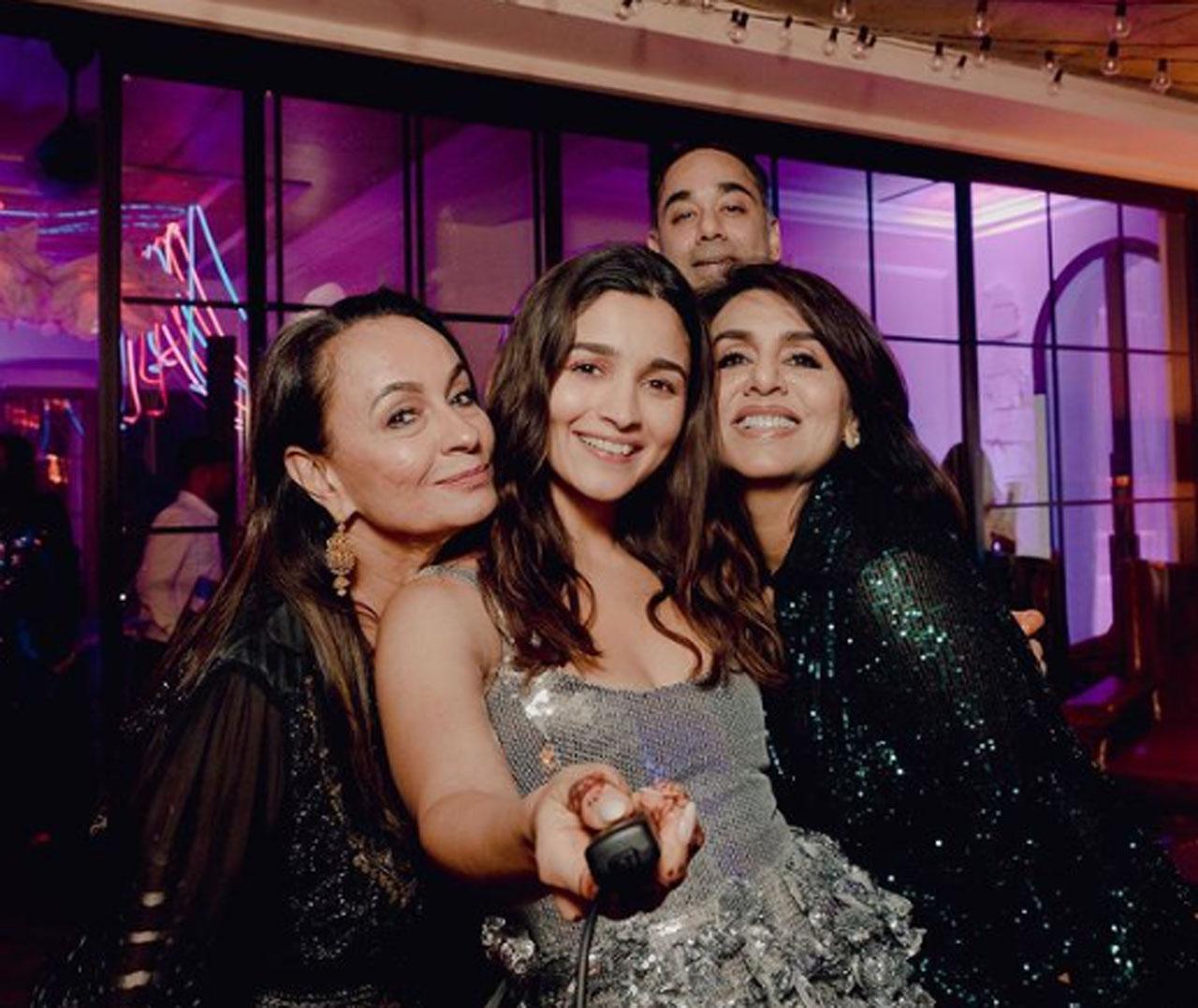 The newest bride in Tinsel Town Alia Bhatt shared an adorable picture with her two mothers- Soni Razdan and Neetu Kapoor. The ladies rocked in the selfie. Recently, Soni Razdan's sister Tina Razdan shared an unseen picture from Alia Bhatt and Ranbir Kapoor's wedding festivities. In the image, Ranbir is seen holding Alia in his arms. Also seen in the fam-jam snap are Ranbir's mother Neetu Kapoor, sister Riddhima Kapoor Sahni, Alia's father Mahesh Bhatt, and her sister Shaheen Bhatt, mother Soni Razdan, Ranbir's aunt Rima Jain and cousin Nitasha Nanda and niece Samara.