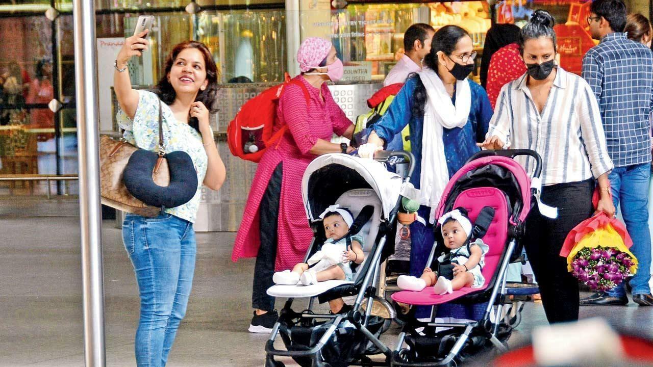 Almost famous: A woman takes a selfie with twin babies as they arrive at the Chhatrapati Shivaji Maharaj International Airport on Saturday. Pic/Sayyed Sameer Abedi 