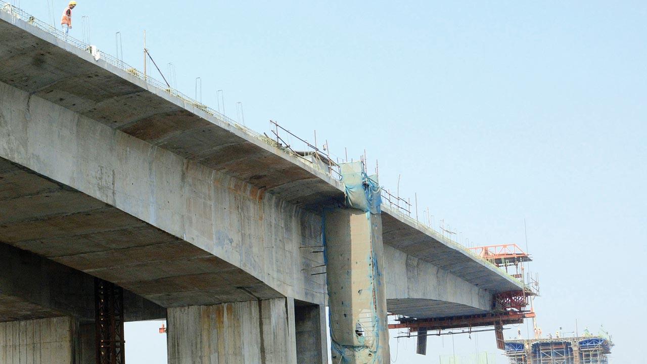 A worker throws debris into the river