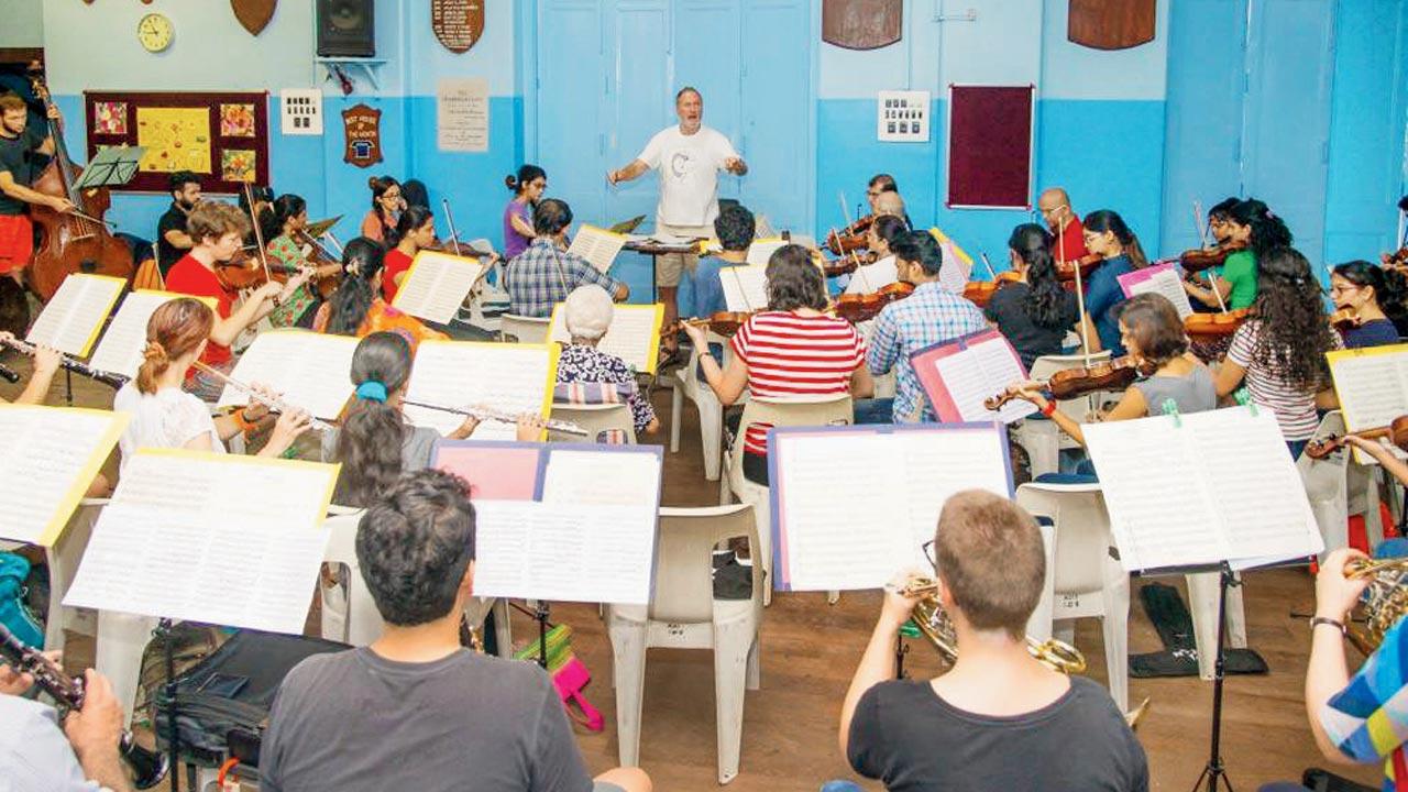 The orchestra rehearses before a performance